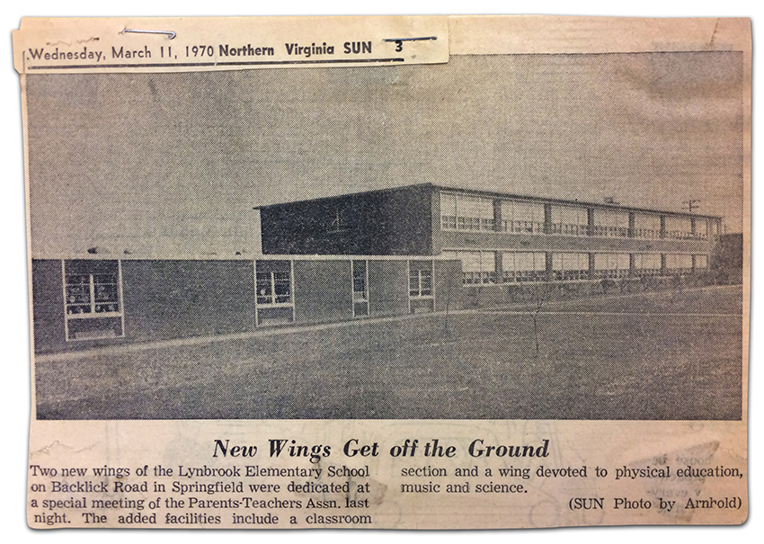Newspaper clipping of an article printed on Wednesday, March 11, 1970, in the Northern Virginia Sun newspaper. The article has a black and white photograph of the front exterior of Lynbrook Elementary School showing the new pod classroom wing on the left and the original two-story classroom wing on the right. The caption reads: New wings get off the ground. Two new wings of the Lynbrook Elementary School on Backlick Road in Springfield were dedicated at a special meeting of the Parent Teachers Association last night. The added facilities include a classroom section and a wing devoted to physical education, music, and science.