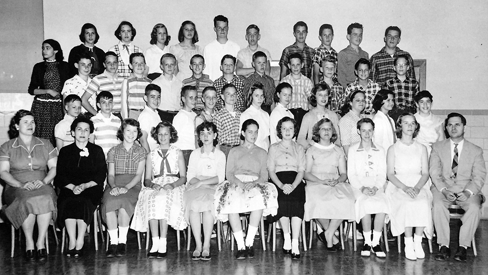 Black and white photograph of Lynbrook's entire seventh grade class taken in 1958. 42 students and 3 adults are pictured, one of whom is Principal Auerbach.