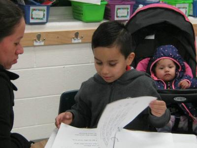 child reads to parents at literacy night